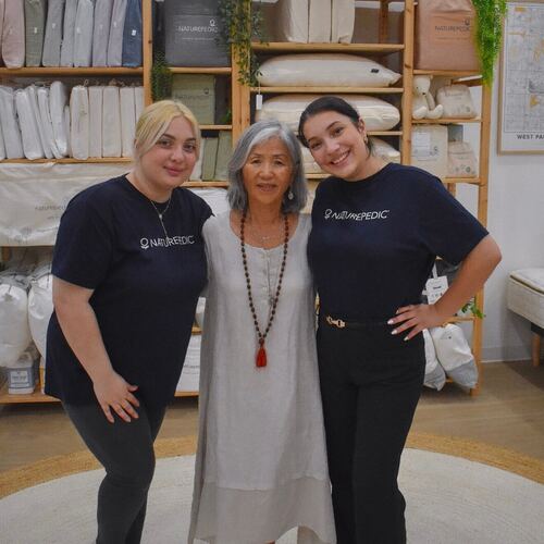 Mi Sun standing with two Naturepedic staff members after the session